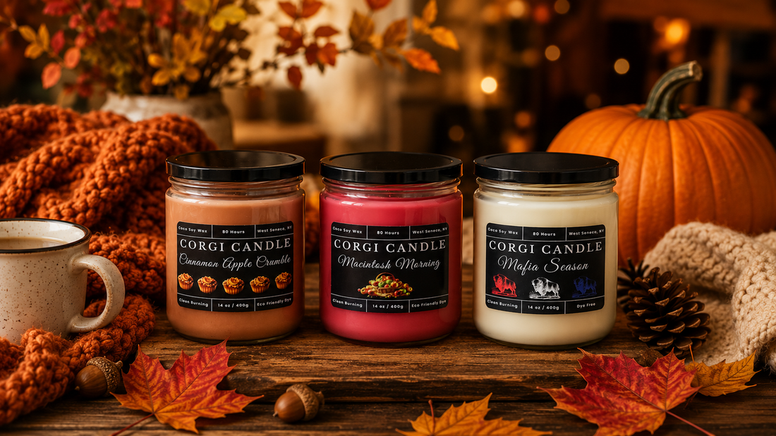 Handmade fall candles in a cozy autumn setting featuring Cinnamon Apple Crumble, Macintosh Morning, and Mafia Season soy candles surrounded by pumpkins, colorful fall leaves, pinecones, and warm seasonal décor.