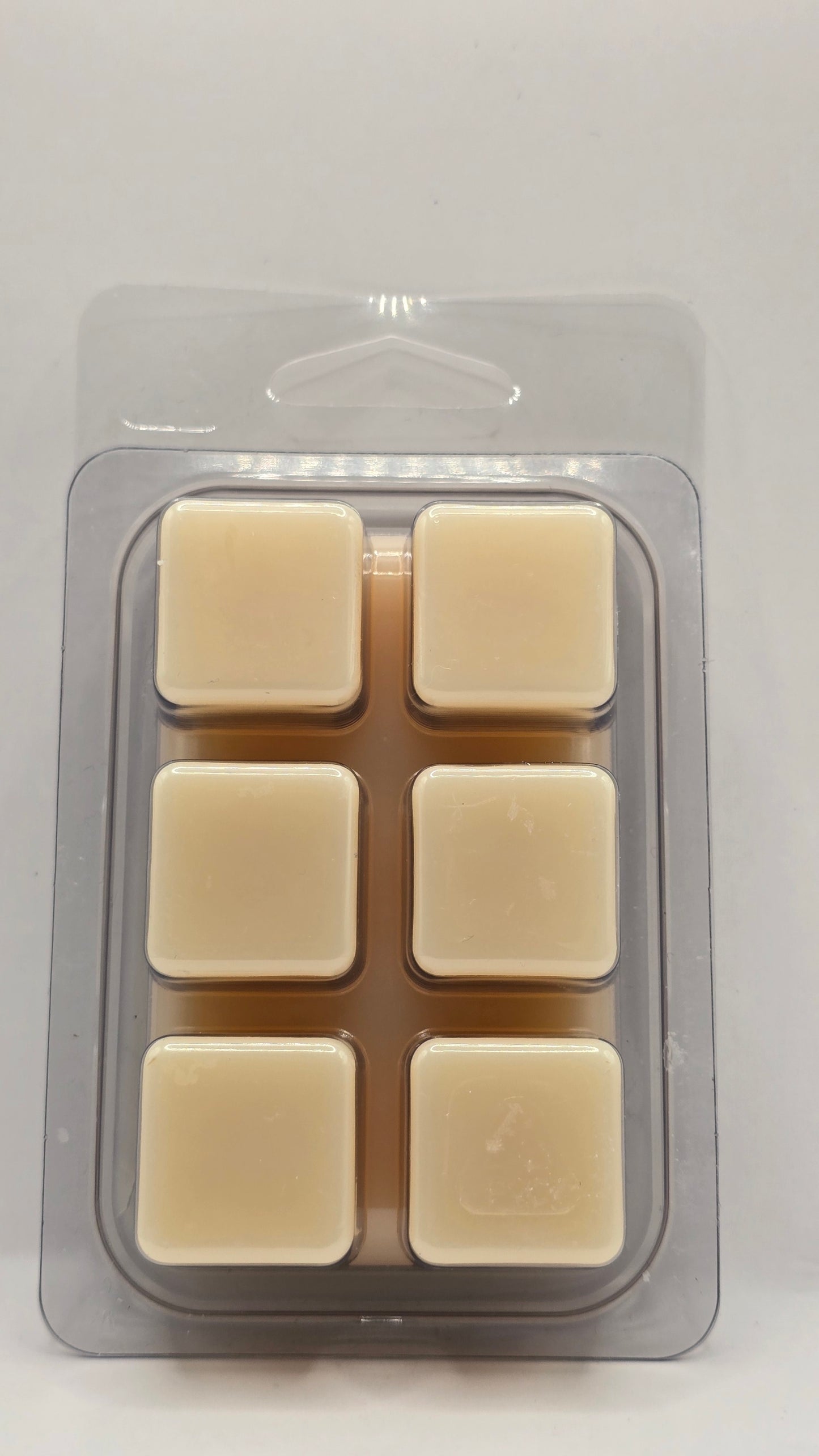 Back of Almost Paradise soy wax melt showing six wax cubes inside clear plastic clamshell packaging.