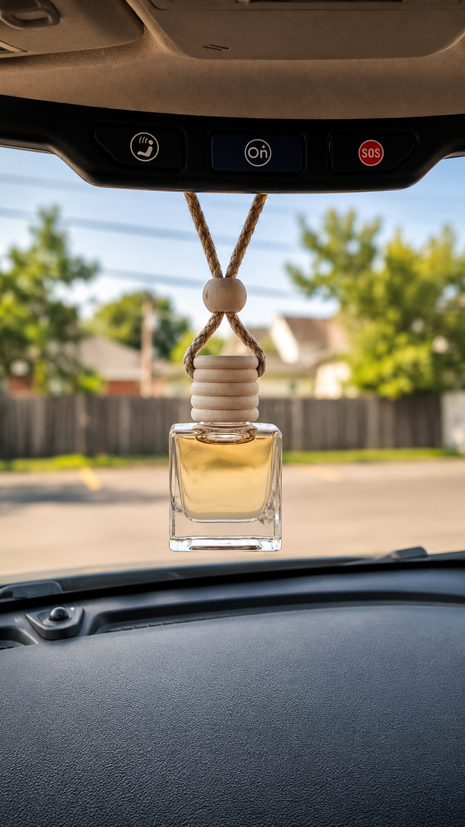 CORGI CANDLE hanging car diffuser with premium fragrance oil displayed from a rearview mirror inside a vehicle.