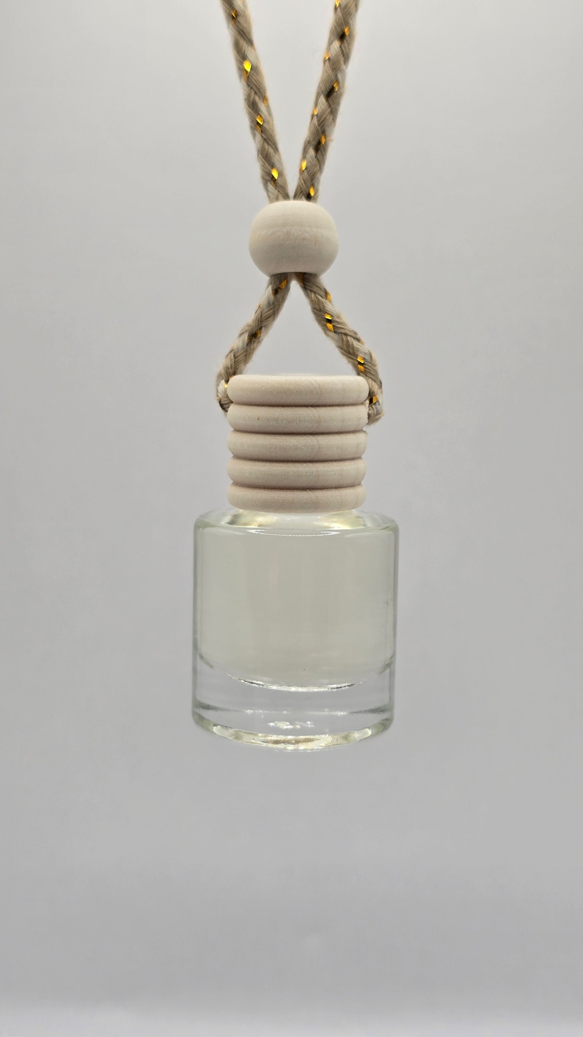 Glass 8 ml bottle with a white cap and beige cord on a light gray background