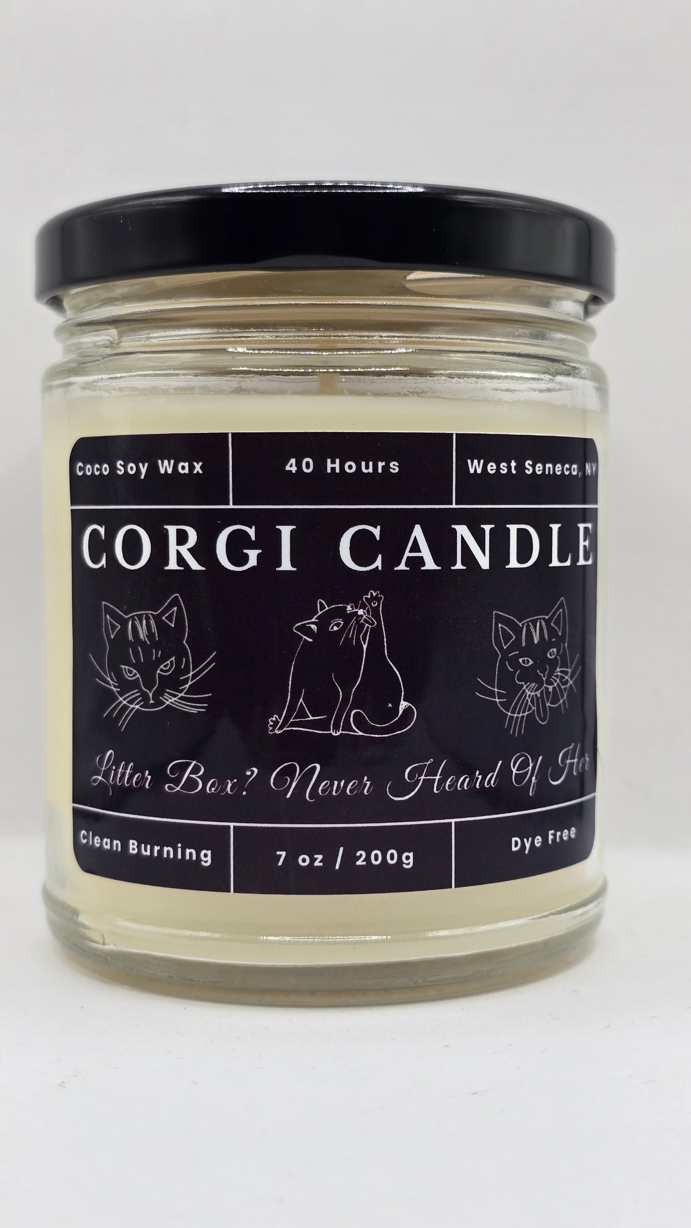 CORGI CANDLE Litter Box? Never Heard Of Her 7 oz soy candle in a clear glass jar with black lid on a white background.