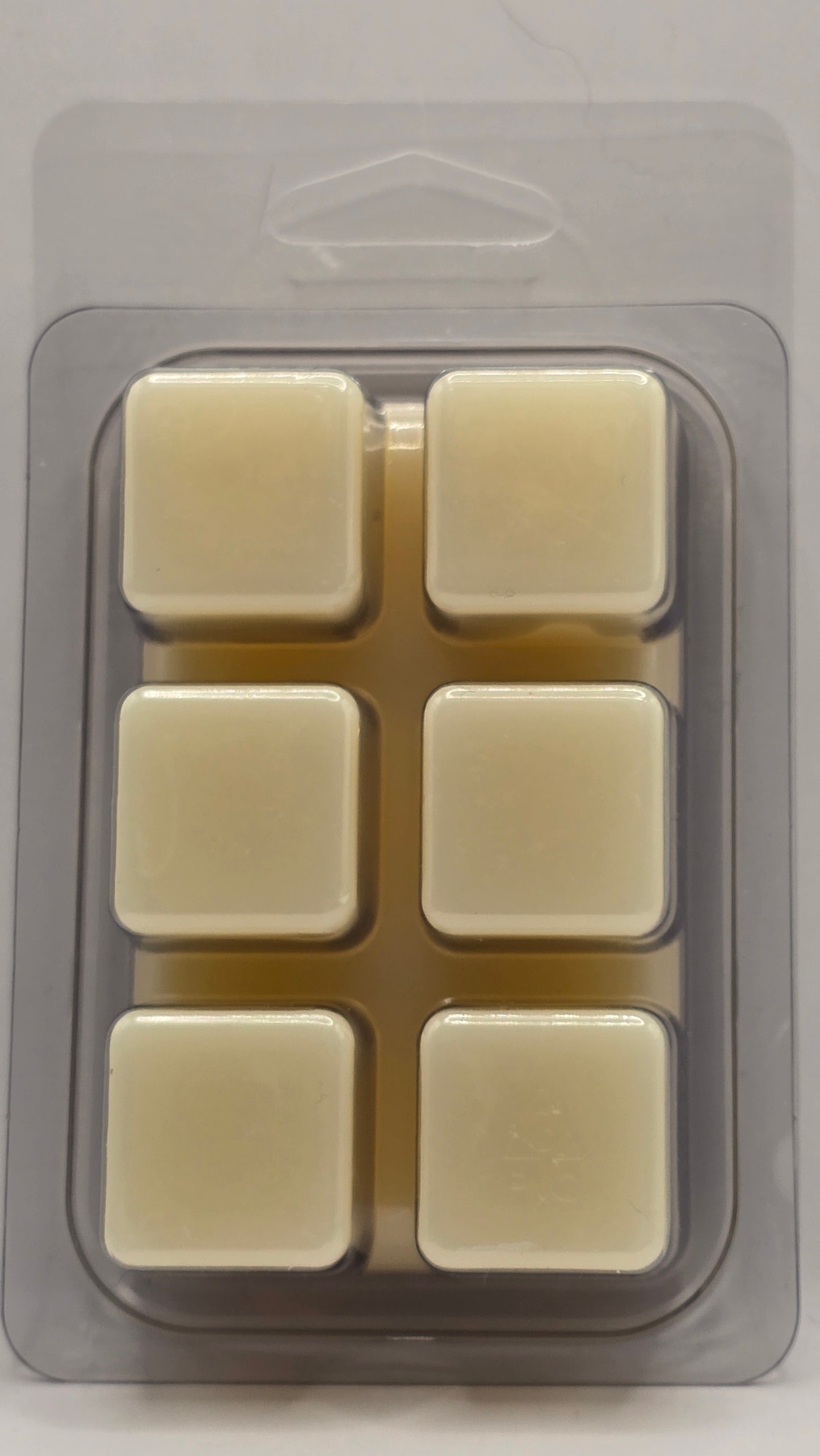 Silicone mold with six square cavities on a gray background