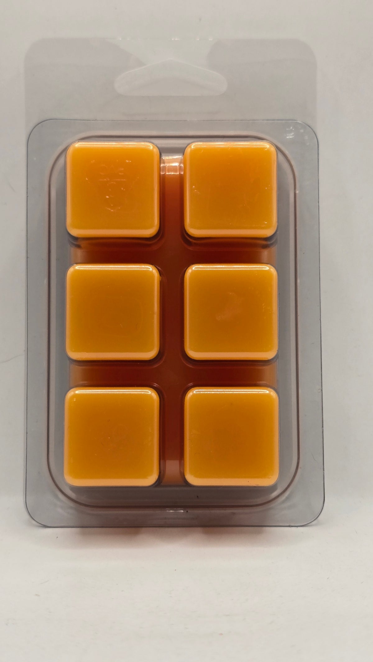 Back view of the Corgi Candle Oranges and Cream 2.7 oz soy wax melt clamshell, showing six bright orange wax cubes. Hand-poured soy wax melts inspired by the classic orange creamsicle fragrance, offering a clean, long-lasting home fragrance experience.