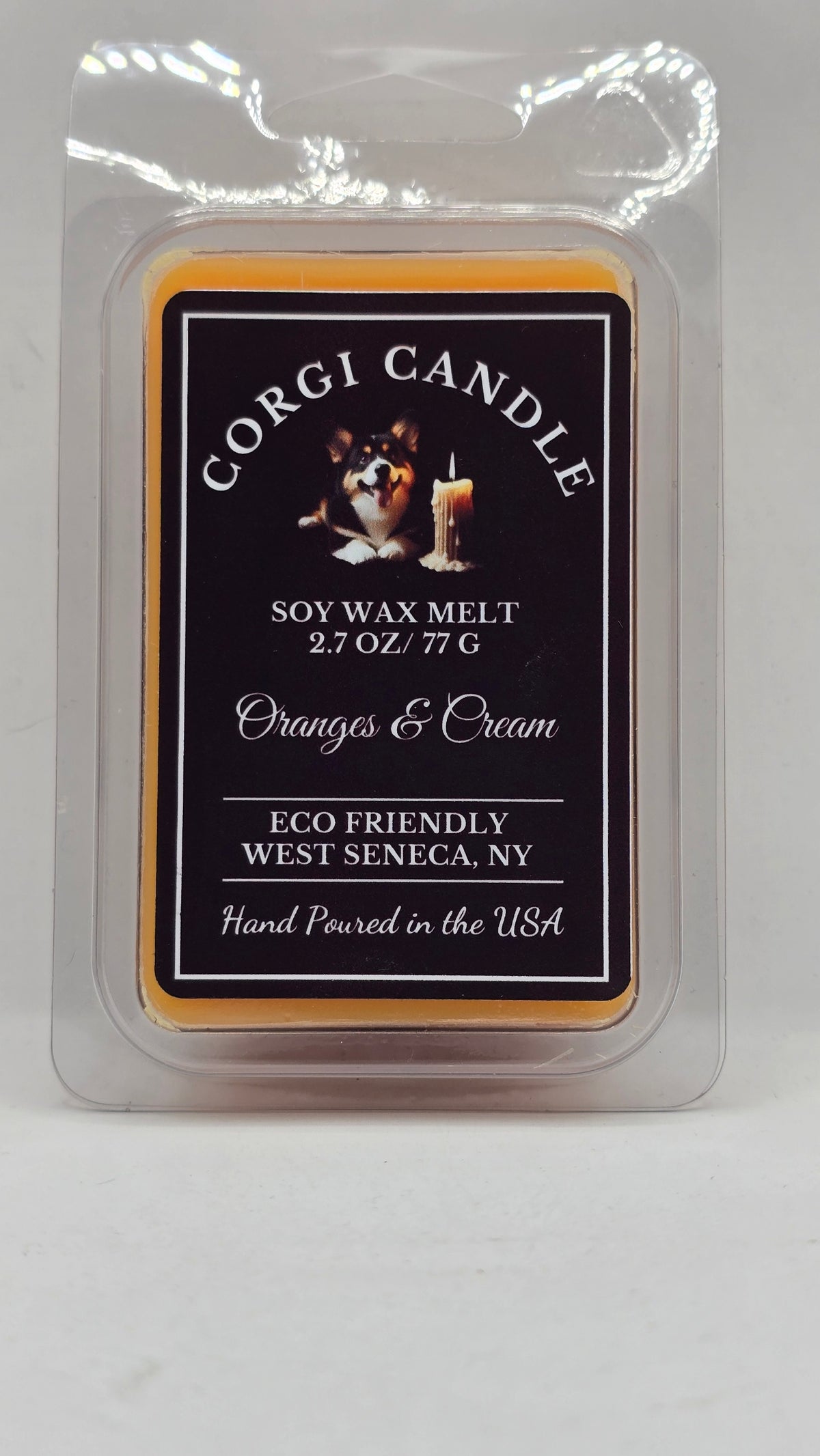 Corgi Candle Oranges and Cream soy wax melt in a 2.7 oz clamshell package with a black label, inspired by the nostalgic scent of an orange creamsicle. Hand-poured with a soy wax blend for a clean, long-lasting fragrance that fills your home with sweet citrus and creamy vanilla.