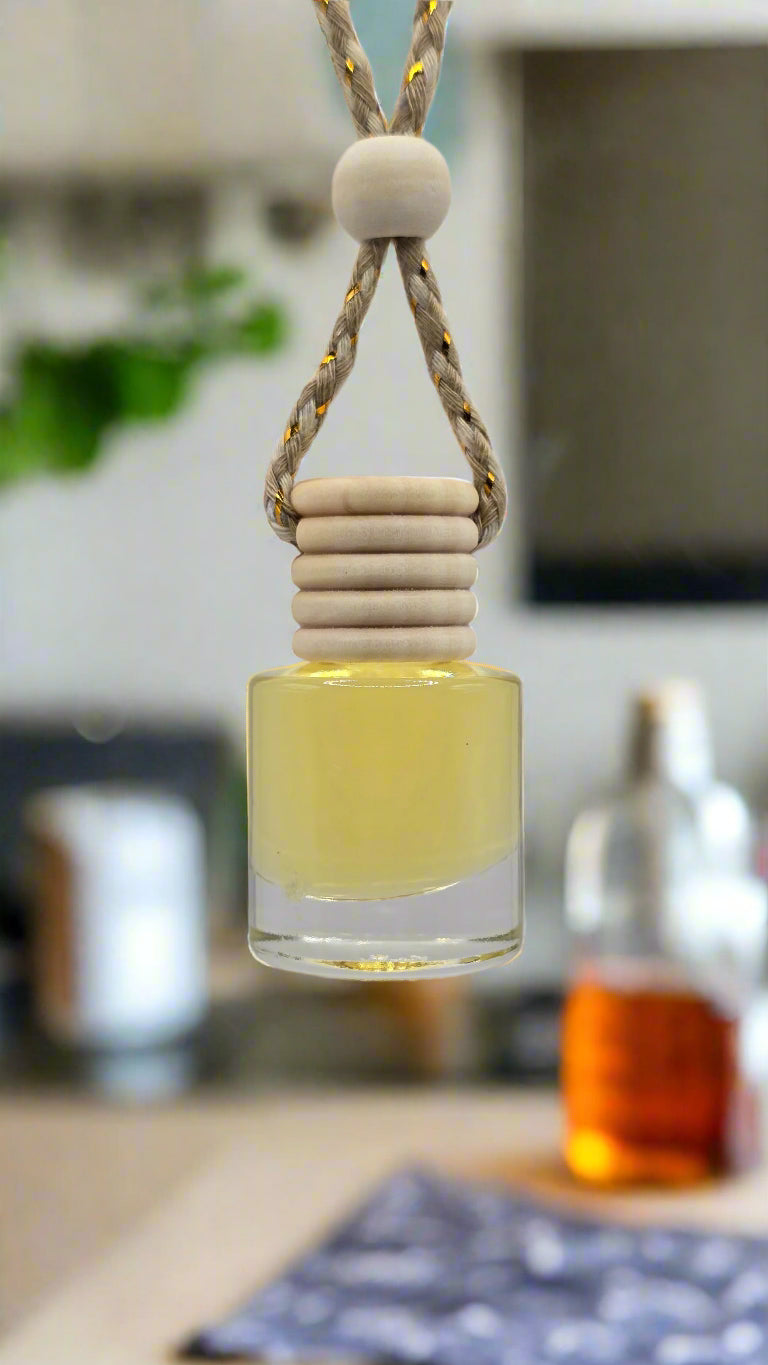 Clear bottle filled with yellow fragrance oil