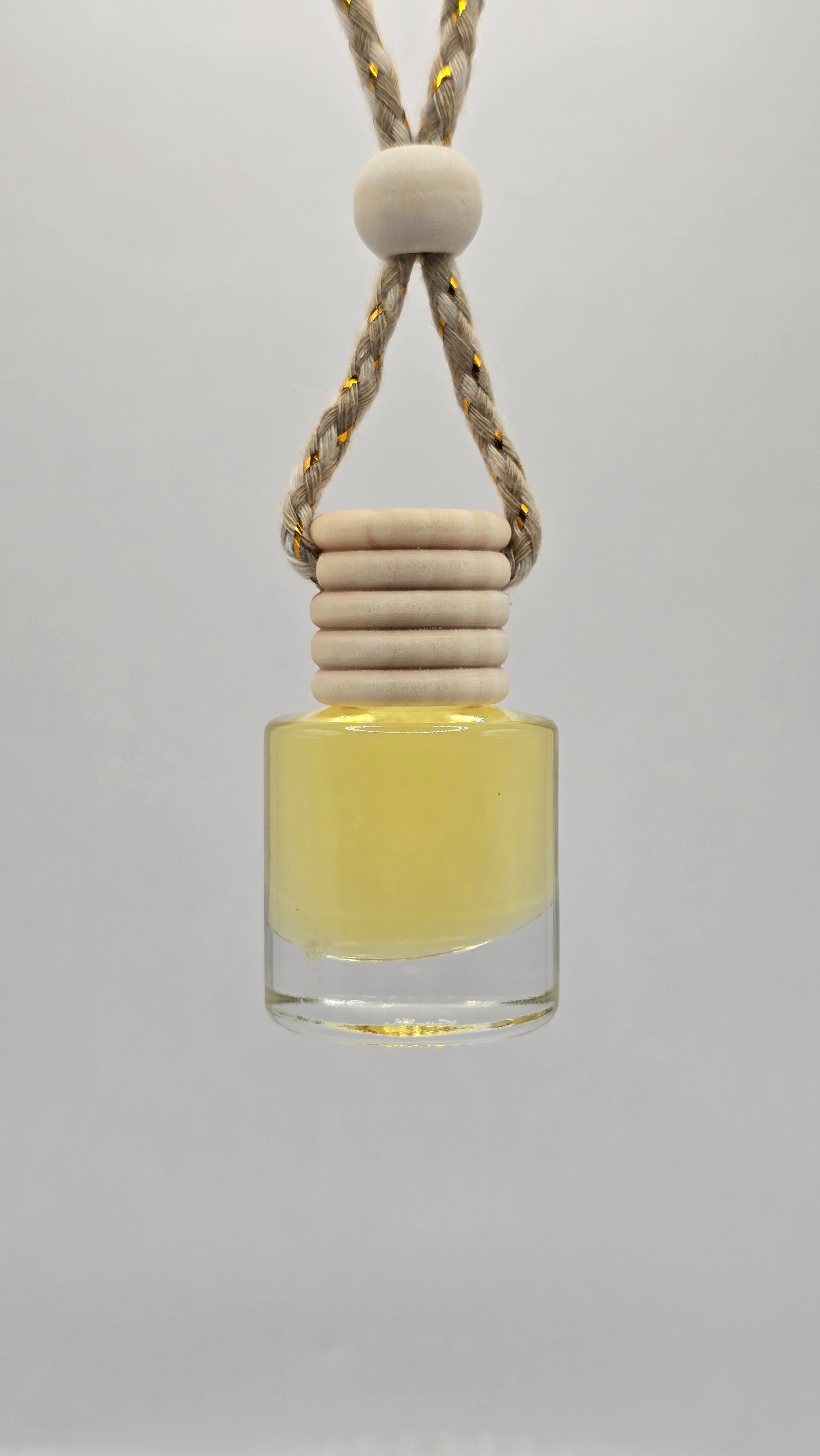 Glass 8 ml bottle with a string and wooden bead on a light gray background