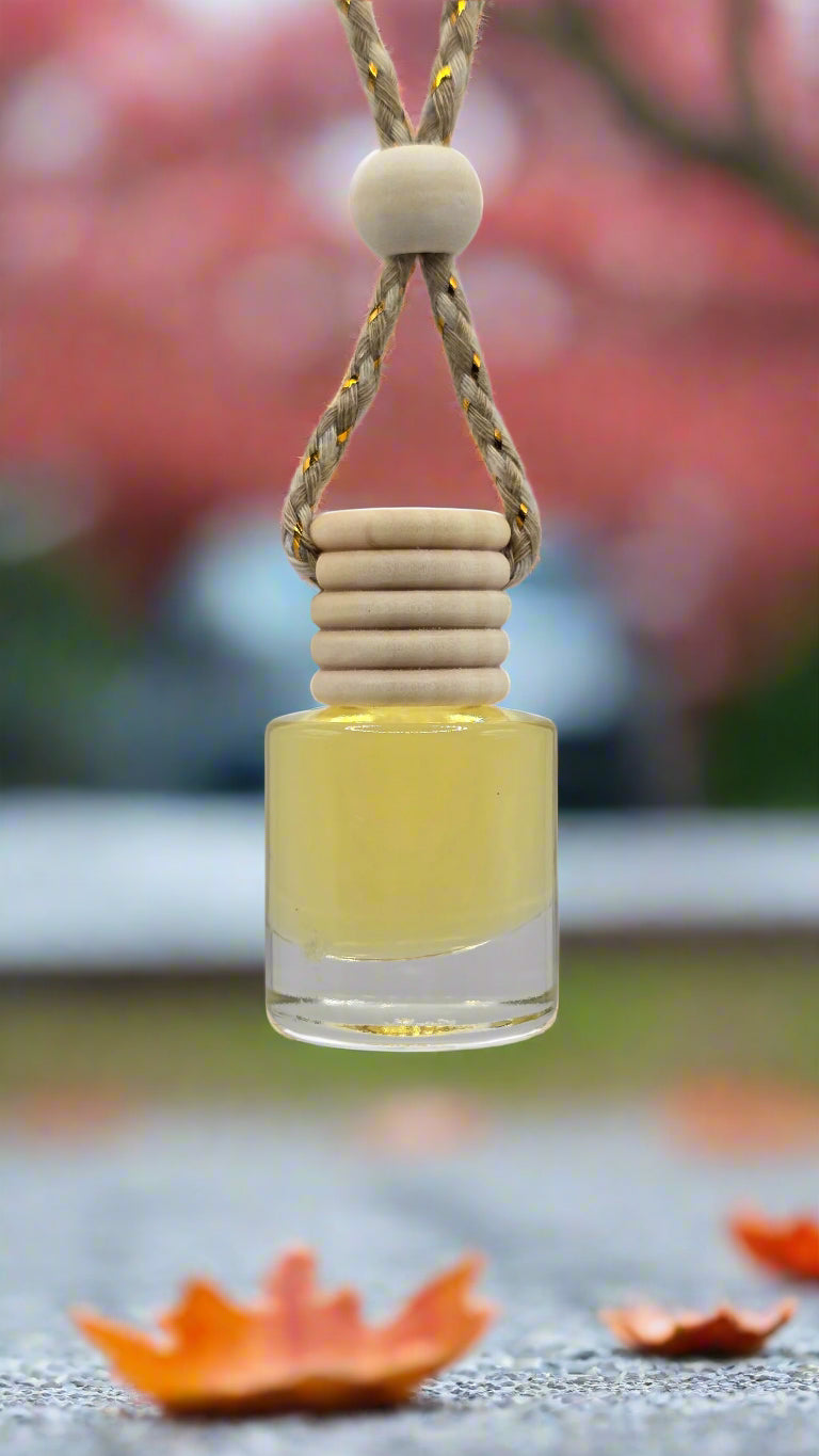 Small glass bottle with a string and wooden bead on a light gray background