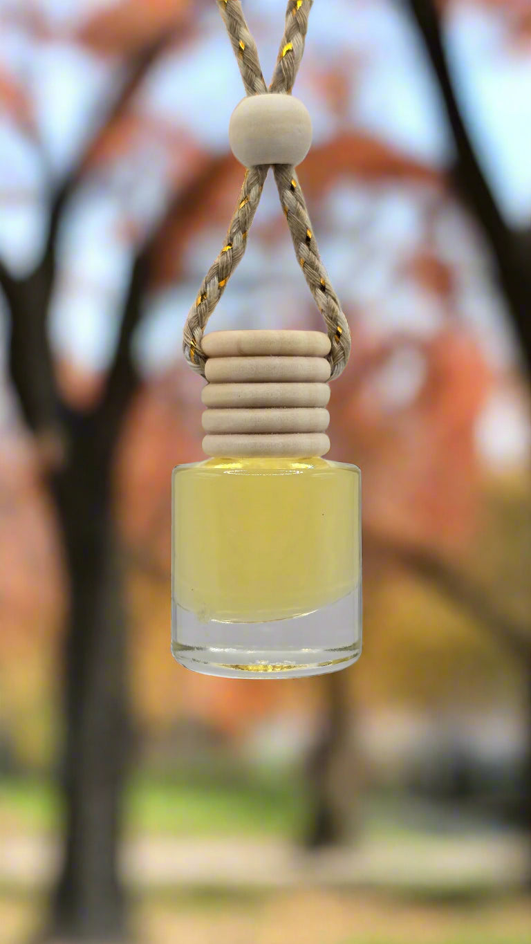 Small glass bottle with a string and wooden bead on a light gray background