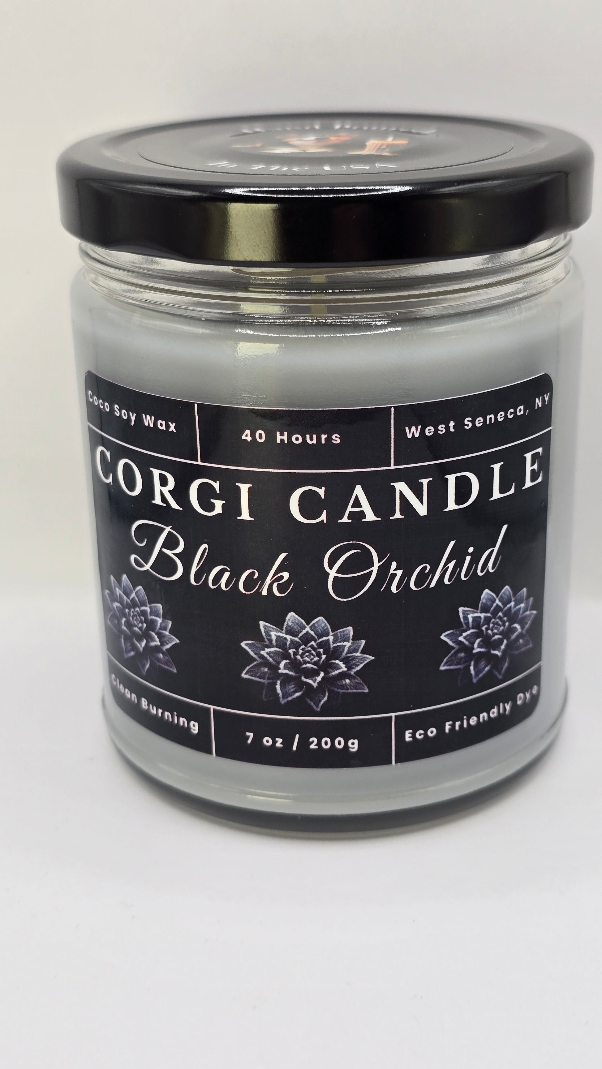 Black Orchid soy candle in a matte black glass jar with a minimalist label featuring a bold floral and woody scent inspired by luxury fragrance, hand-poured by CORGI CANDLE.