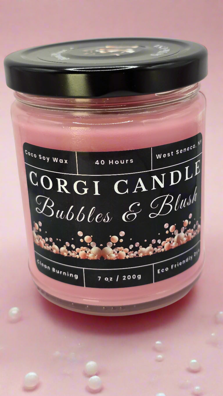 Bubbles & Blush soy candle in a soft pink glass jar with a minimalist label, featuring a Champagne Toast scent with notes of berries, citrus, and vanilla, hand-poured by CORGI CANDLE.