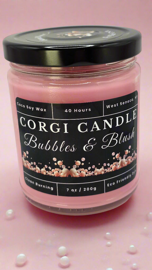 Bubbles & Blush soy candle in a soft pink glass jar with a minimalist label, featuring a Champagne Toast scent with notes of berries, citrus, and vanilla, hand-poured by CORGI CANDLE.