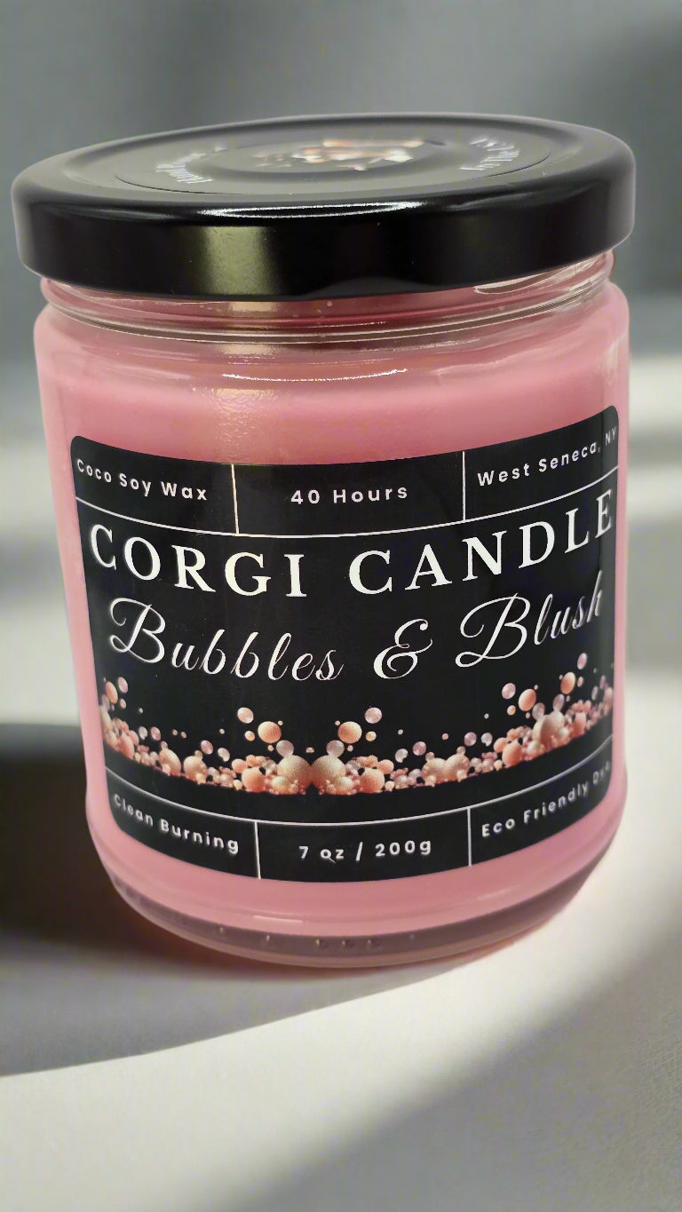 Bubbles & Blush soy candle in a soft pink glass jar with a minimalist label, featuring a Champagne Toast scent with notes of berries, citrus, and vanilla, hand-poured by CORGI CANDLE.
