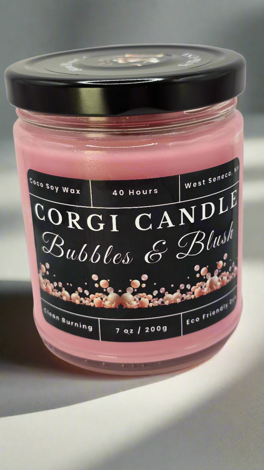 Bubbles & Blush soy candle in a soft pink glass jar with a minimalist label, featuring a Champagne Toast scent with notes of berries, citrus, and vanilla, hand-poured by CORGI CANDLE.