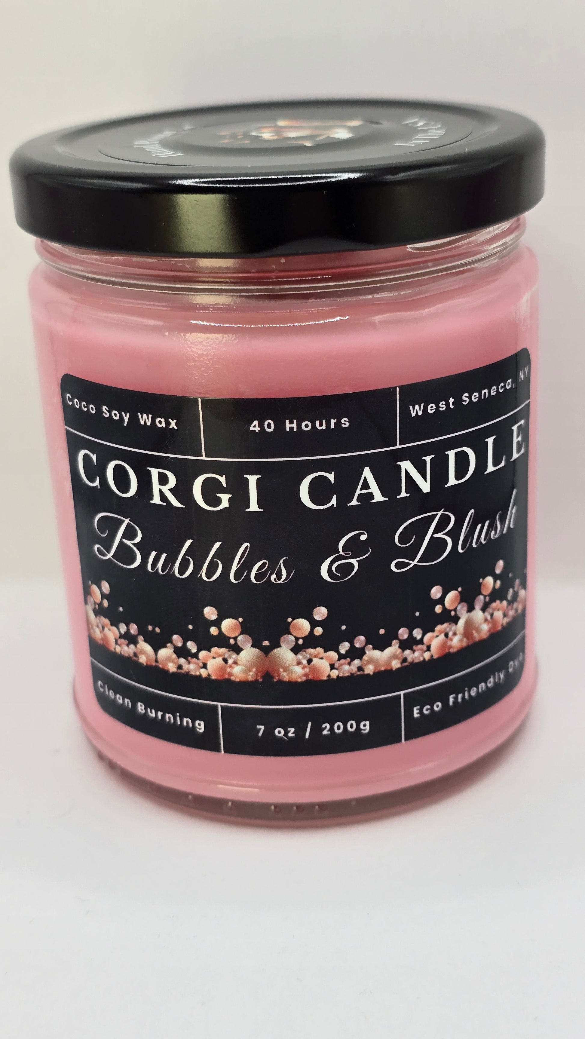 Bubbles & Blush soy candle in a soft pink glass jar with a minimalist label, featuring a Champagne Toast scent with notes of berries, citrus, and vanilla, hand-poured by CORGI CANDLE.