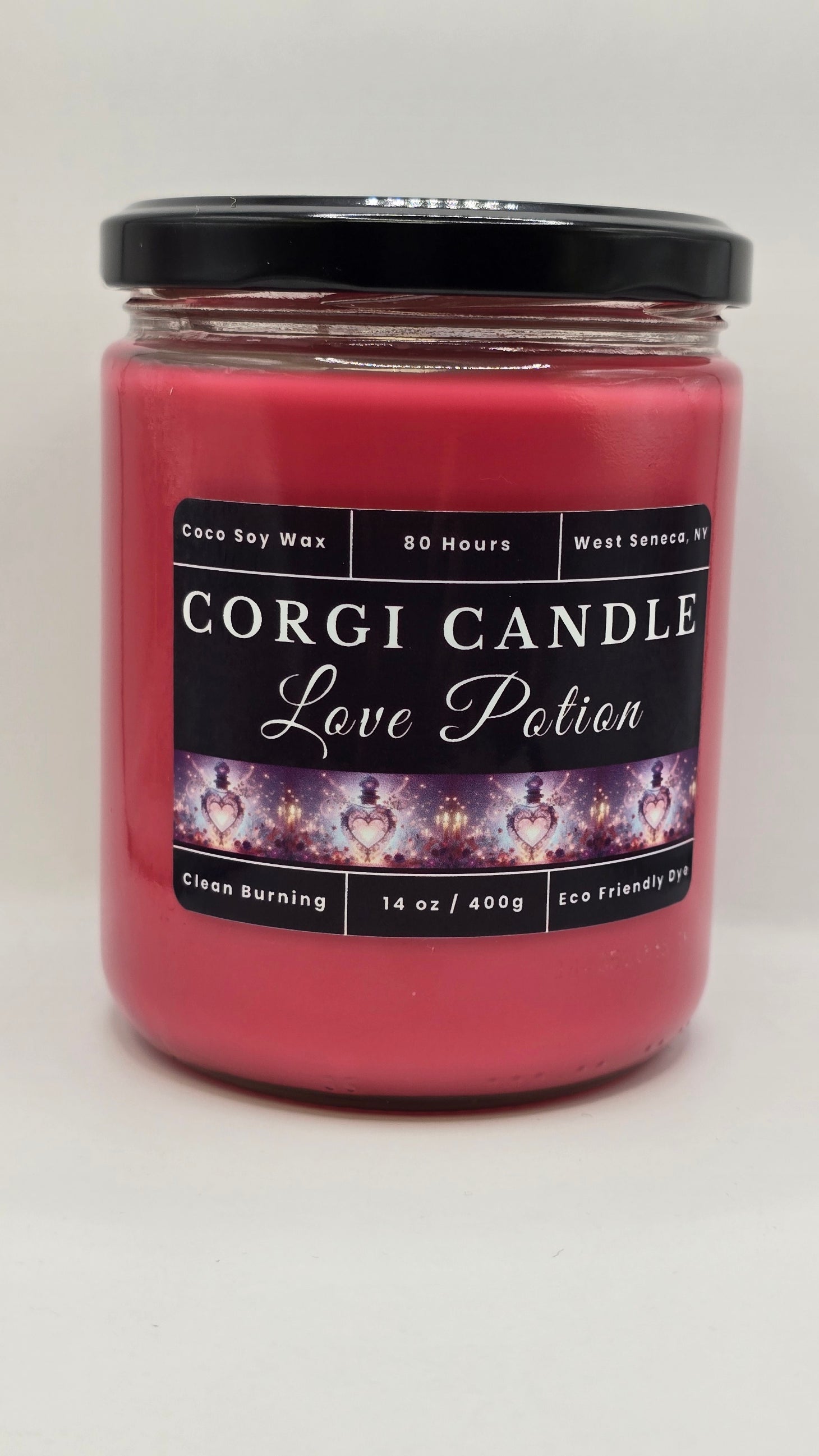 Love Potion soy candle in a romantic-toned glass jar with floral accents, featuring a peach, cherry blossom, and jasmine fragrance by CORGI CANDLE.