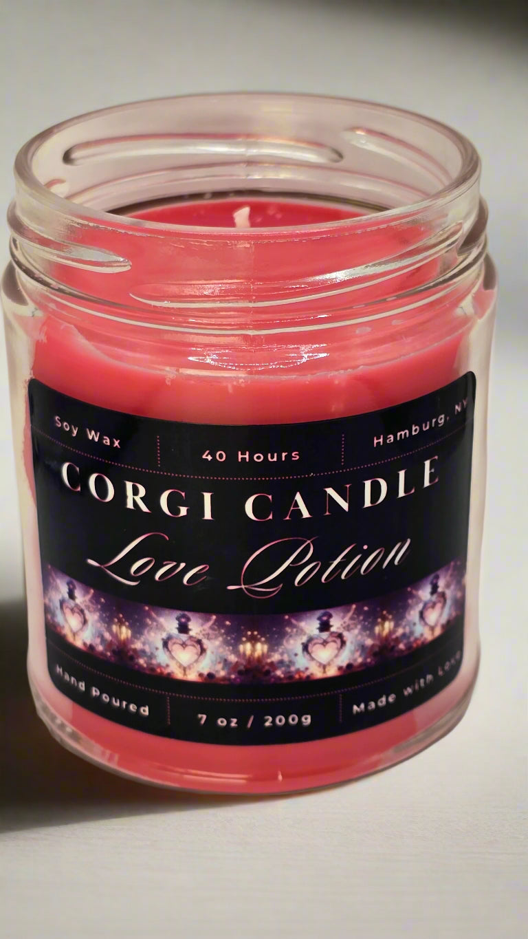 Love Potion 7 oz soy candle in a romantic glass jar with a soft pink label, hand-poured by CORGI CANDLE and scented with a flirty blend of cherry blossom, peach, and white jasmine